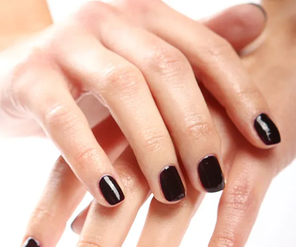 close up hands dark nail polsih