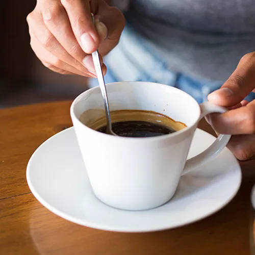 "Stirring coffee in a cup"