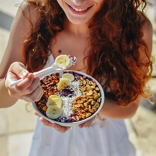 A woman eating breakfast.