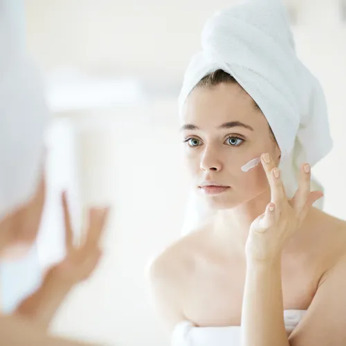 woman looking in mirror