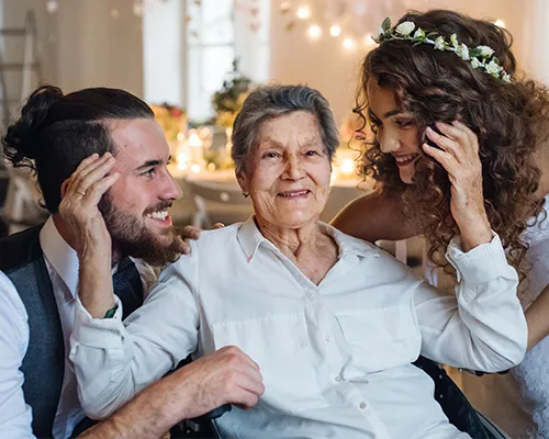 Older guest with bride and groom