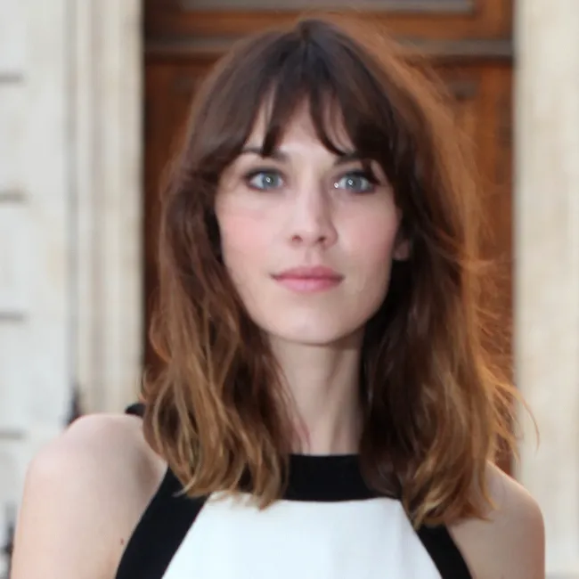alexa chung brown wavy highlighted hair curtain bangs black and white top red carpet