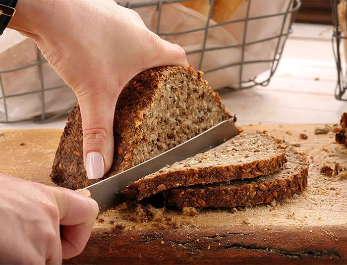 Cutting into whole grain bread