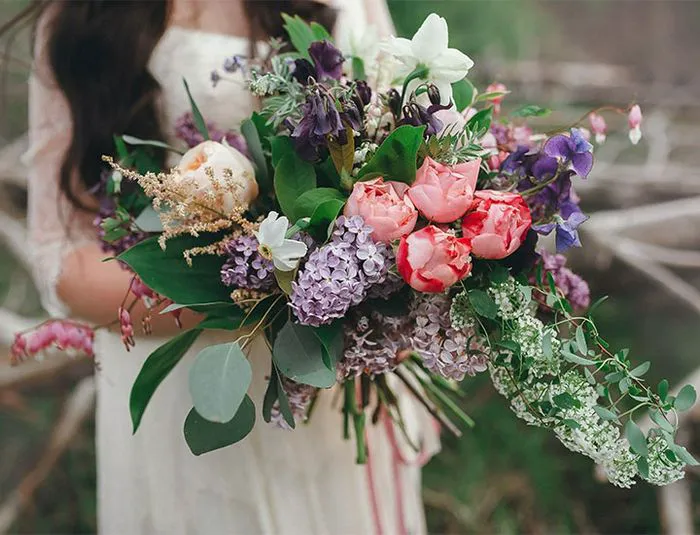 Bride holding oversized boho bouquet