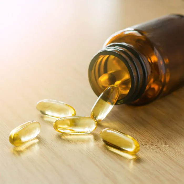 omega 3 supplements spilling out of bottle