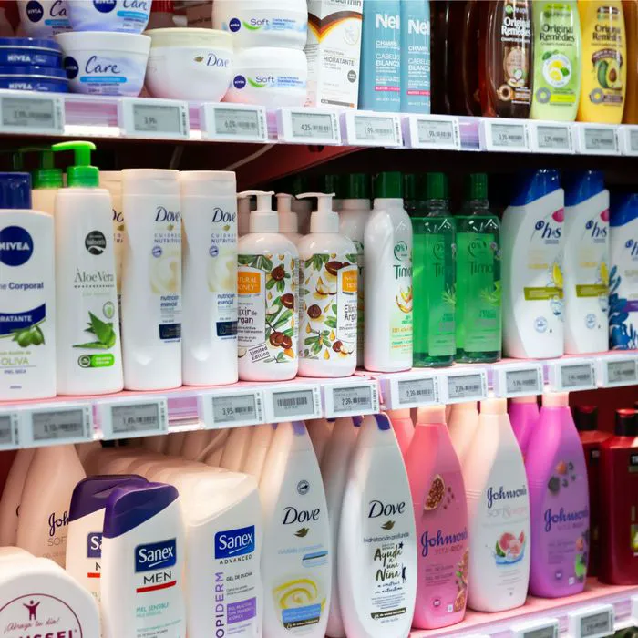 shampoo bottles on drugstore shelf close up