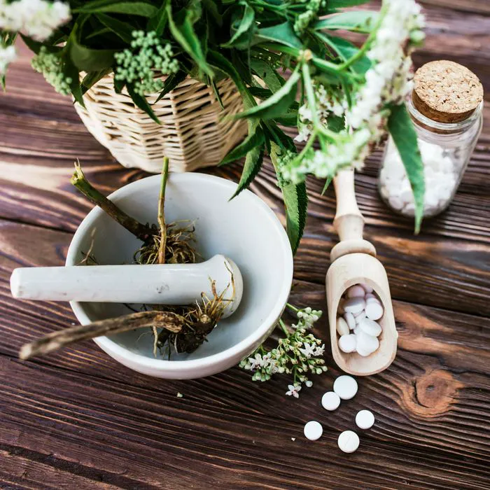valerian root in grinding bowl beside tablets