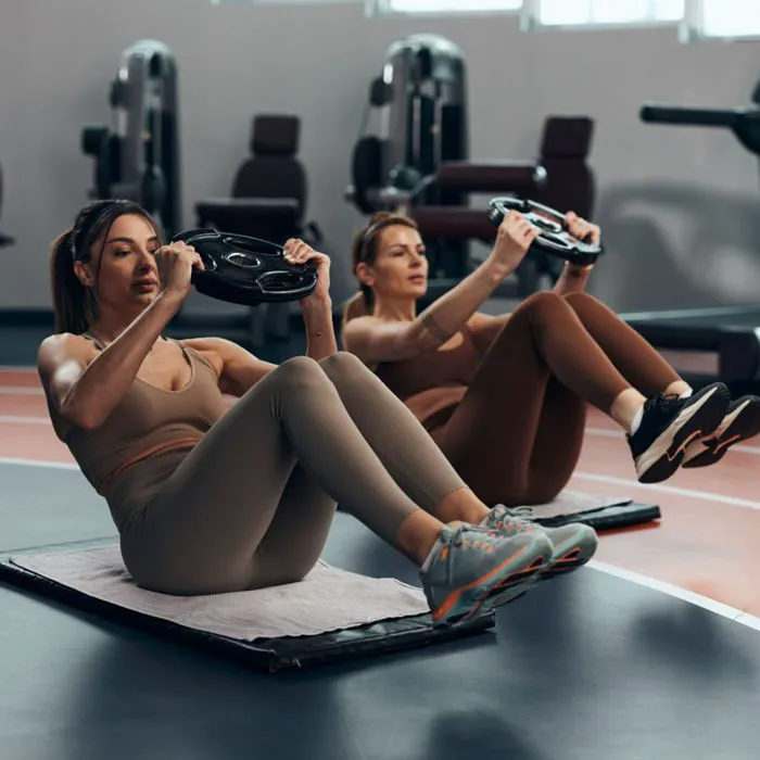 women performing sit ups