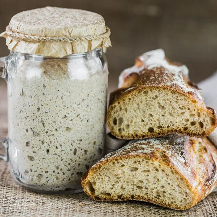 sourdough next to sourdough starter jar