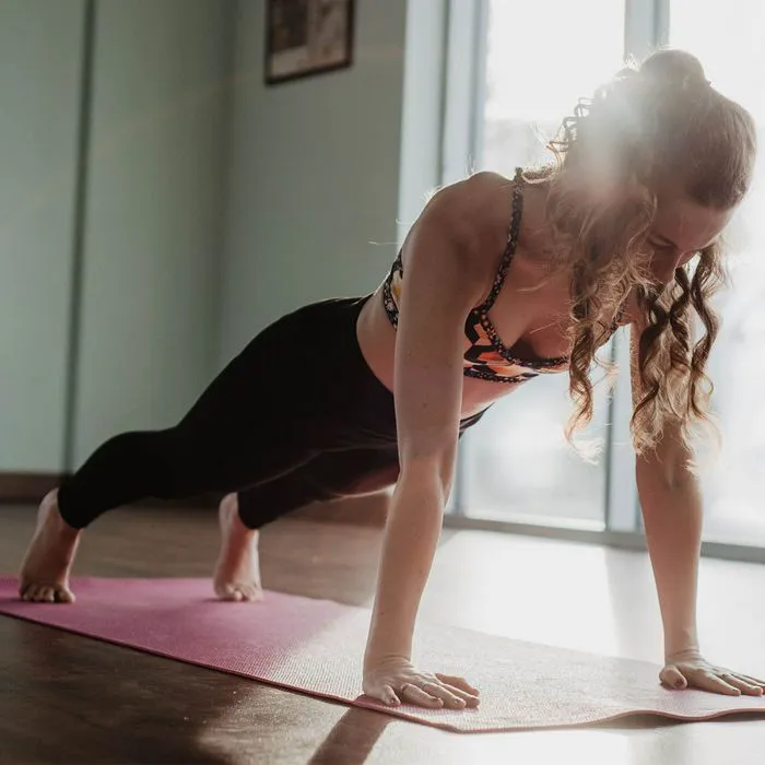 woman doing plank at home