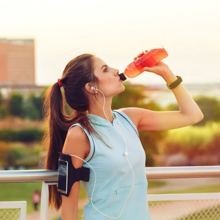woman drinking sports drink