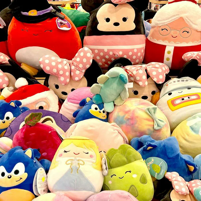 "Piles of Squishmallows at a store"