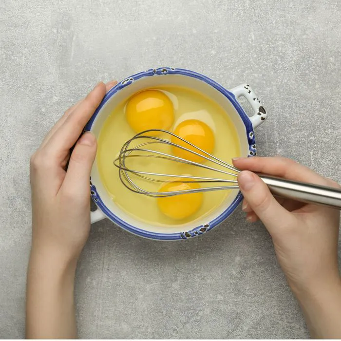 woman whisking eggs