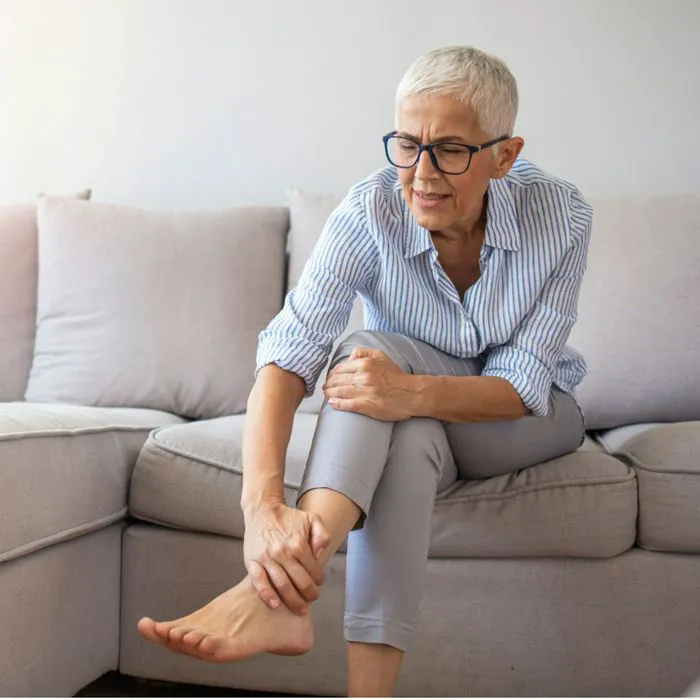 woman holding her ankle