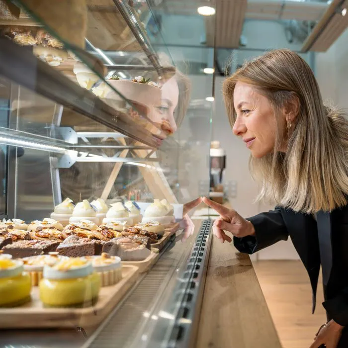 woman looking at cupcakes