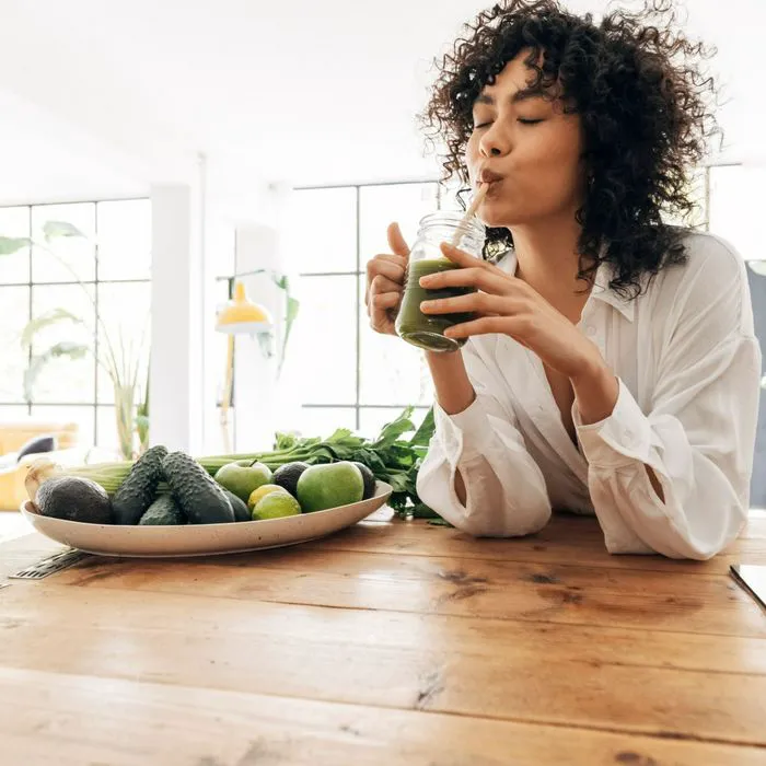 woman drinking green juice