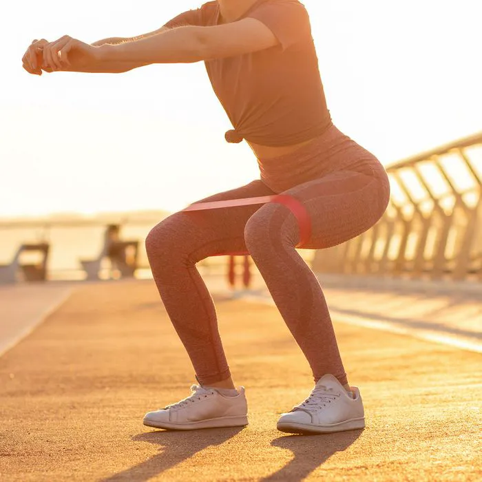 "Woman working out her arms in a gray outfit"
