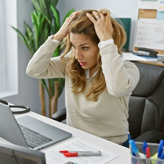 woman struggling to concentrate at desk