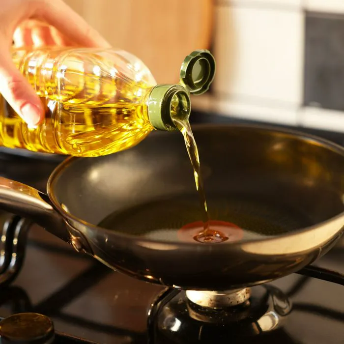 vegetable oil pouring into pan