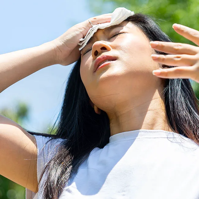"Woman sweating outside during high-intensity workout"