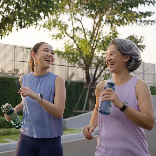 Two women walking together for health and fitness.