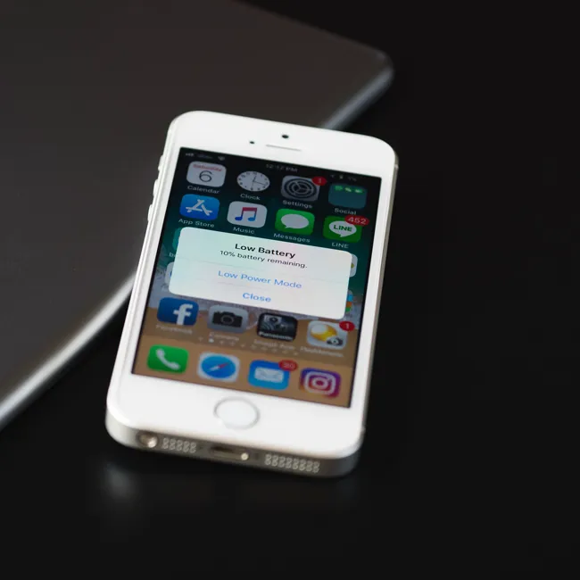 iPhone displaying a low battery alert on the screen