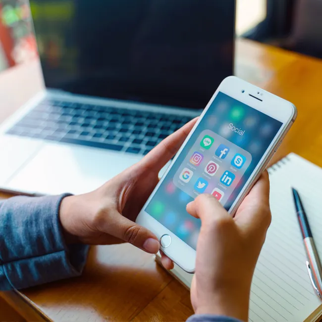 Man looking at social media apps on his phone