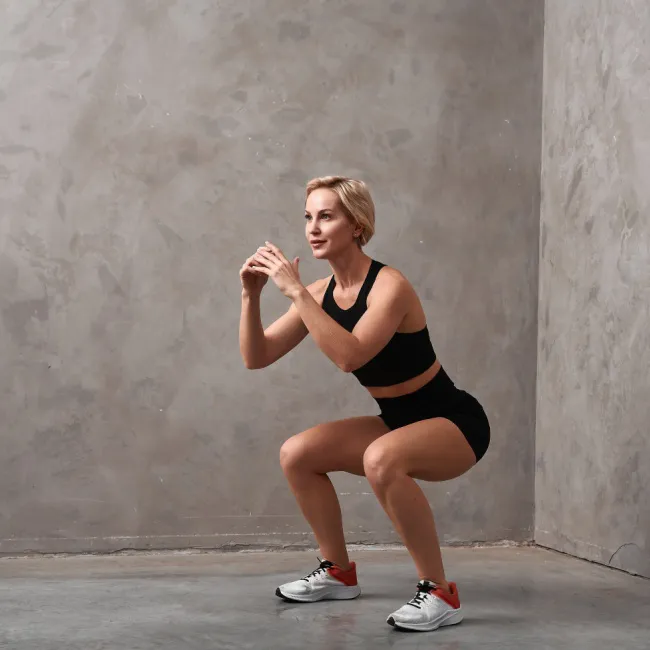 "Woman performing a plank exercise in a gym"