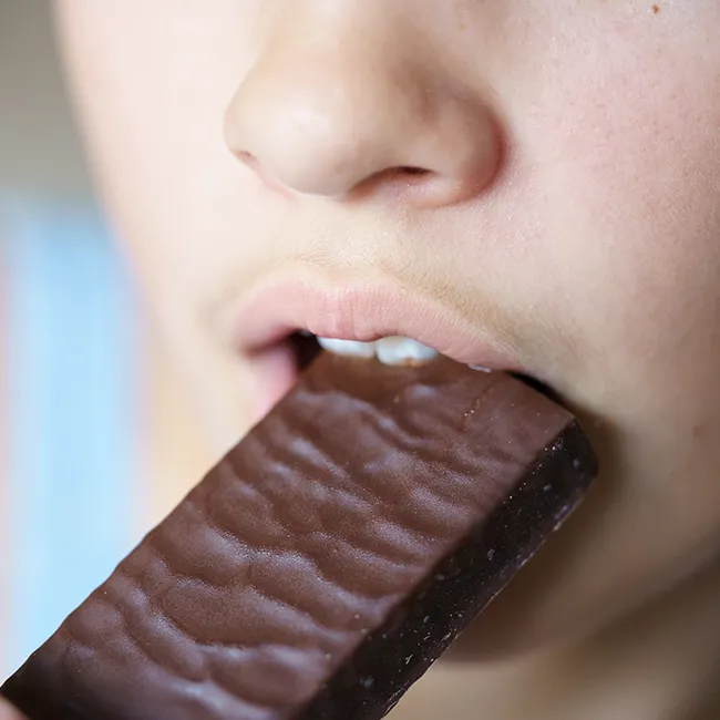 "Biting into a protein bar"