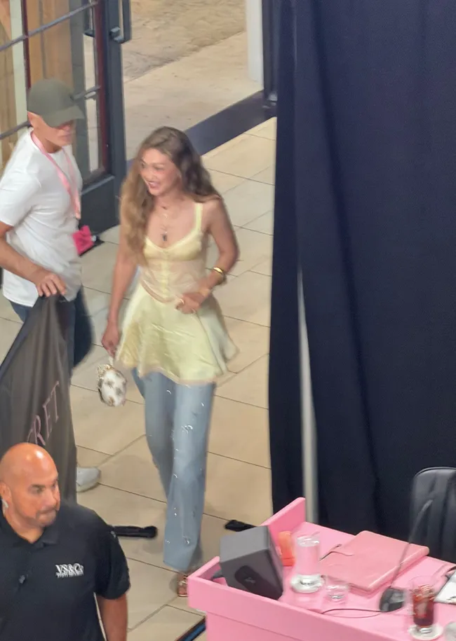 "Gigi Hadid wearing a babydoll dress over jeans at Victoria's Secret casting"