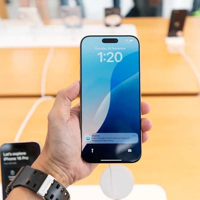"Person holding an iPhone while using it"