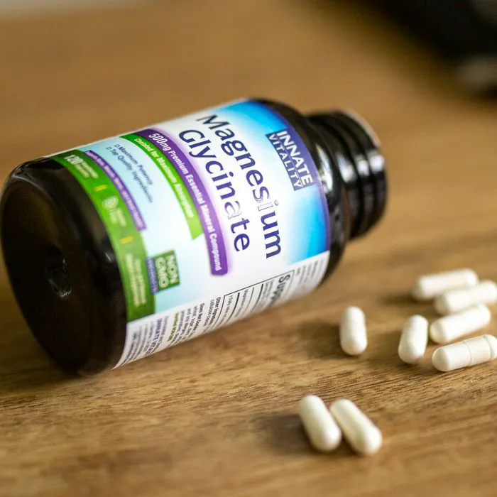"Close-up of magnesium glycinate pills on a wooden surface"