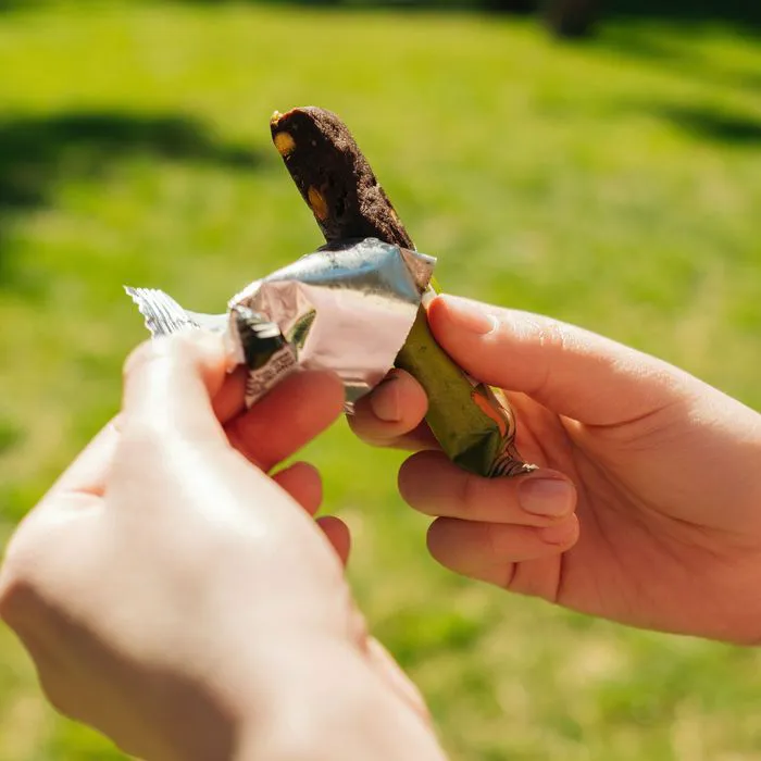 "Opened protein bar with a bite taken out"