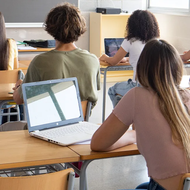 "Students in a classroom using mobile phones"