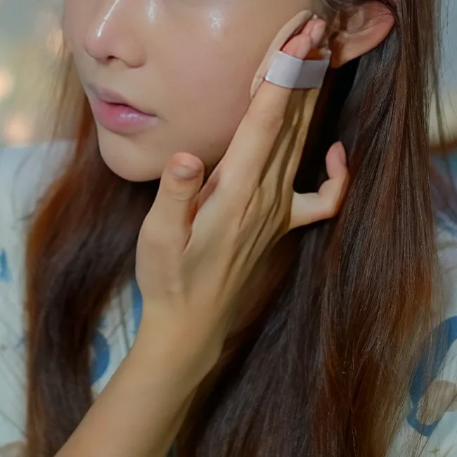 Woman applying makeup for a flawless finish.