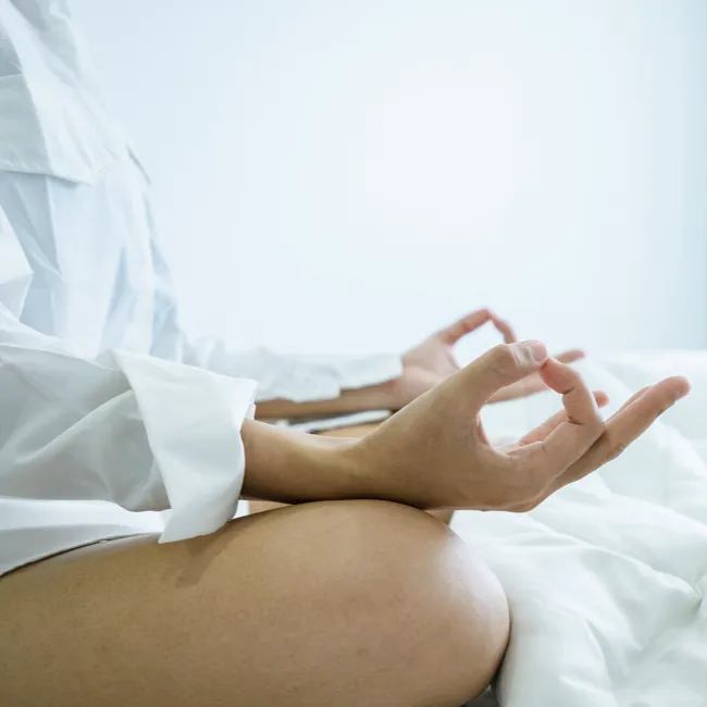"Woman meditating in a calm environment"