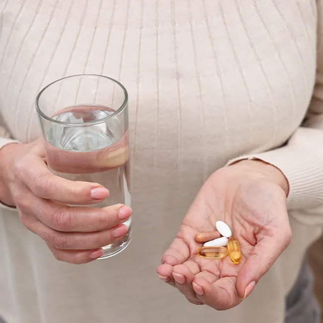 "Woman taking dietary supplements"
