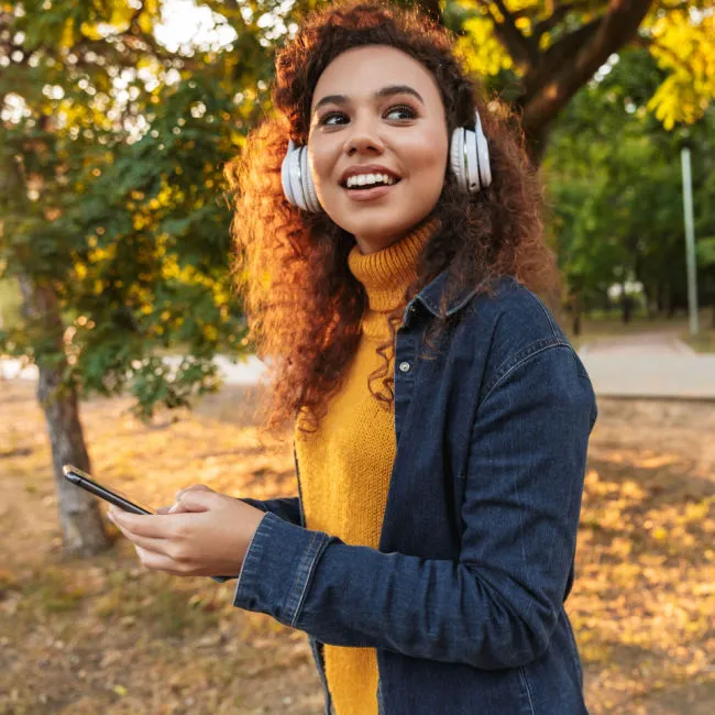 "Woman walking outdoors enjoying nature"