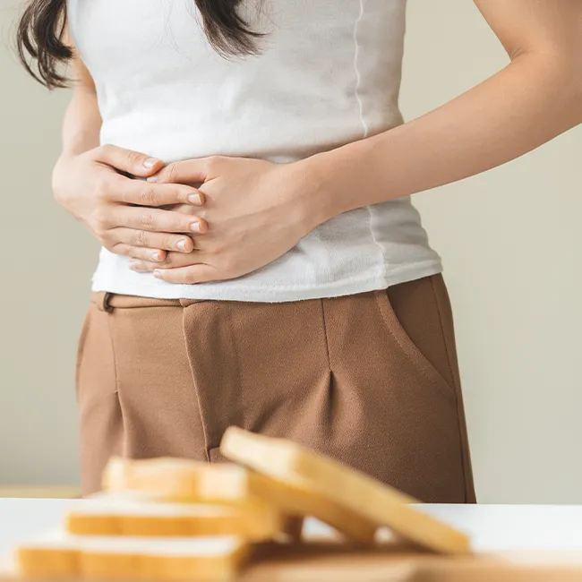 "Woman with stomach pain and white bread"